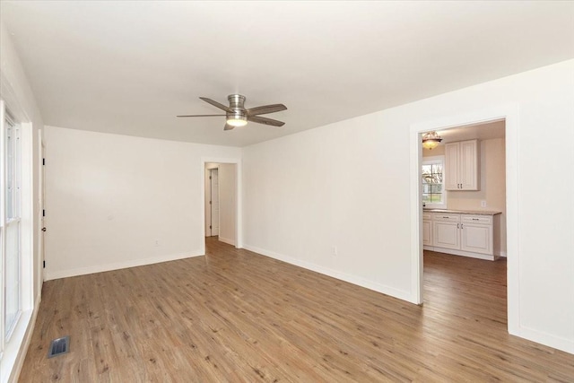 unfurnished room with ceiling fan and light hardwood / wood-style floors