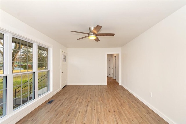 spare room with light hardwood / wood-style floors and ceiling fan