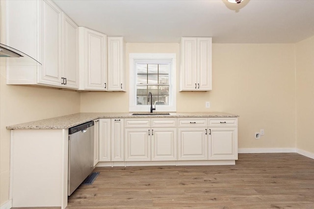 kitchen with white cabinetry, sink, light stone counters, light hardwood / wood-style flooring, and stainless steel dishwasher