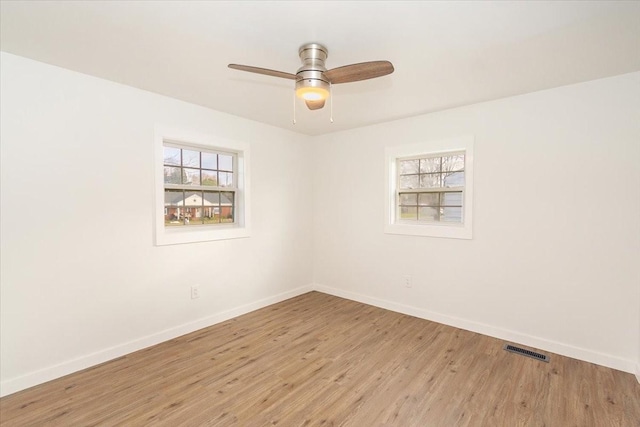 unfurnished room with ceiling fan, light hardwood / wood-style flooring, and a healthy amount of sunlight