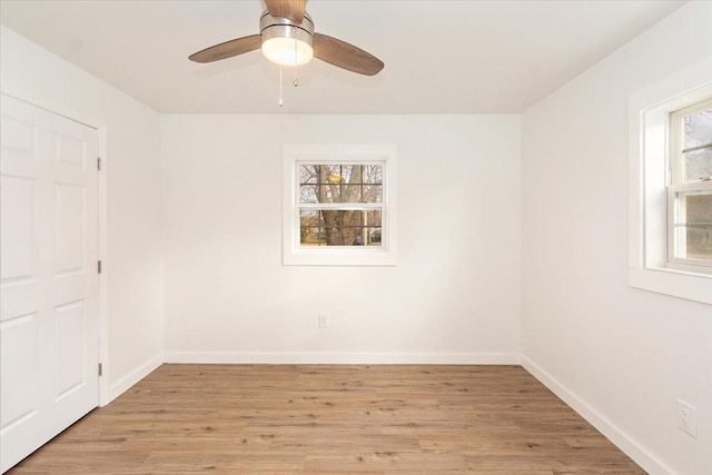 spare room with light wood-type flooring and ceiling fan