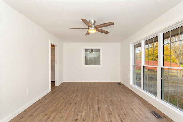 unfurnished room with ceiling fan and light wood-type flooring