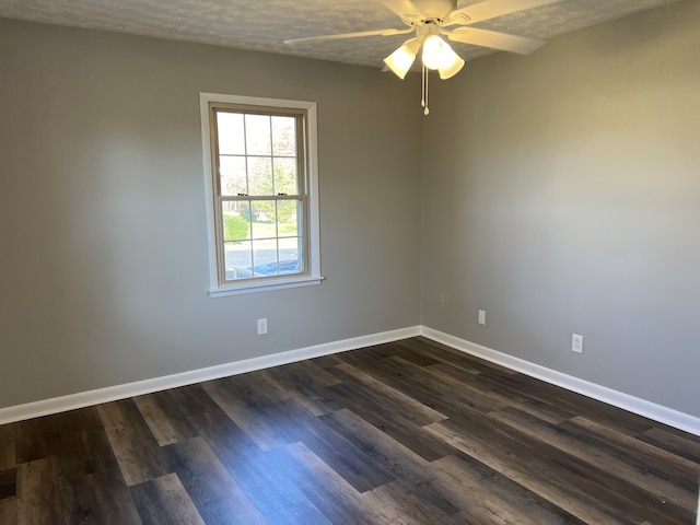 spare room with ceiling fan, dark wood-type flooring, and a textured ceiling