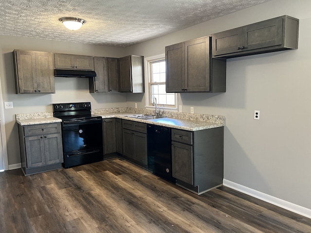 kitchen featuring dark hardwood / wood-style flooring, black appliances, a textured ceiling, and sink