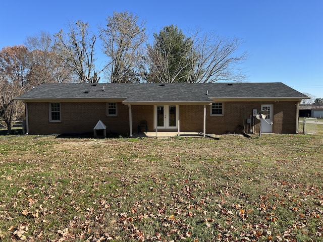 rear view of property with a lawn