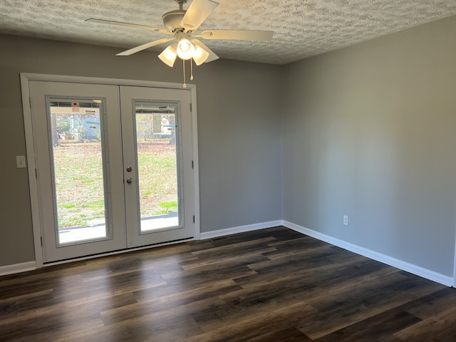 interior space featuring dark hardwood / wood-style flooring, french doors, and a textured ceiling