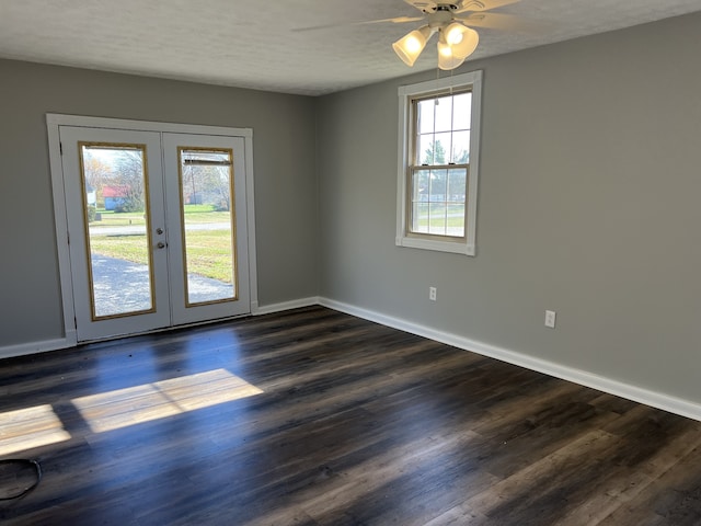 unfurnished room with dark hardwood / wood-style flooring, ceiling fan, french doors, and a textured ceiling