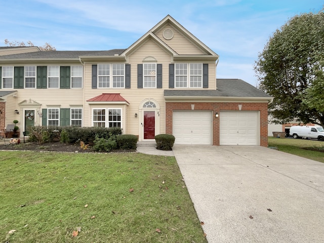 view of front of house with a garage and a front yard