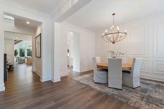 dining space featuring crown molding, dark hardwood / wood-style floors, and an inviting chandelier