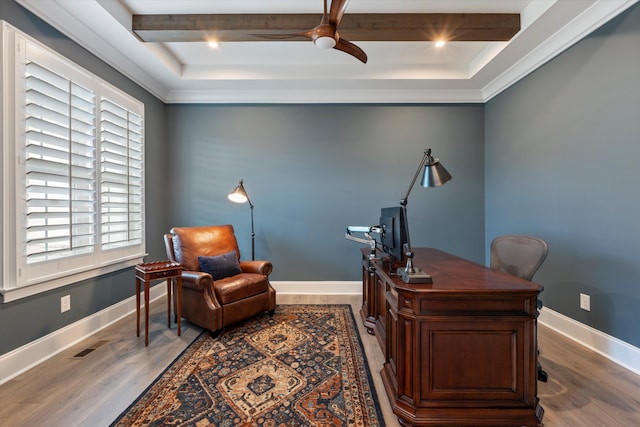 office area with hardwood / wood-style flooring, ceiling fan, beam ceiling, and a raised ceiling