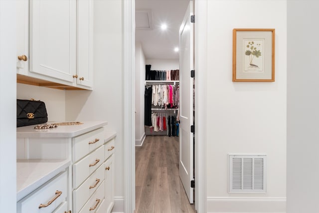 walk in closet featuring light hardwood / wood-style floors