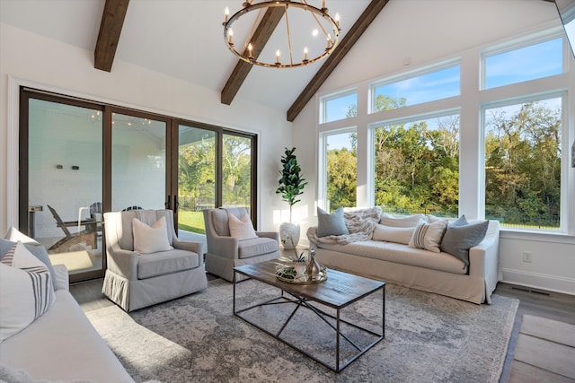 sunroom with french doors, lofted ceiling with beams, and a notable chandelier