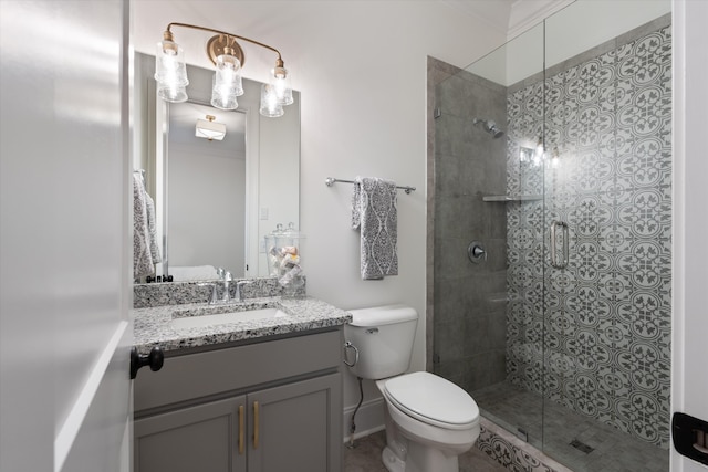 bathroom with vanity, toilet, and an enclosed shower