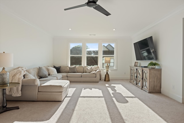 living room featuring crown molding, ceiling fan, and light colored carpet