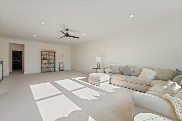 living room featuring ceiling fan, light colored carpet, and ornamental molding