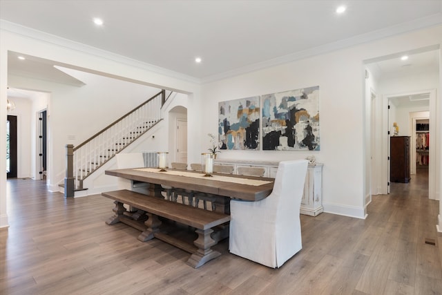 dining area featuring light hardwood / wood-style flooring and ornamental molding