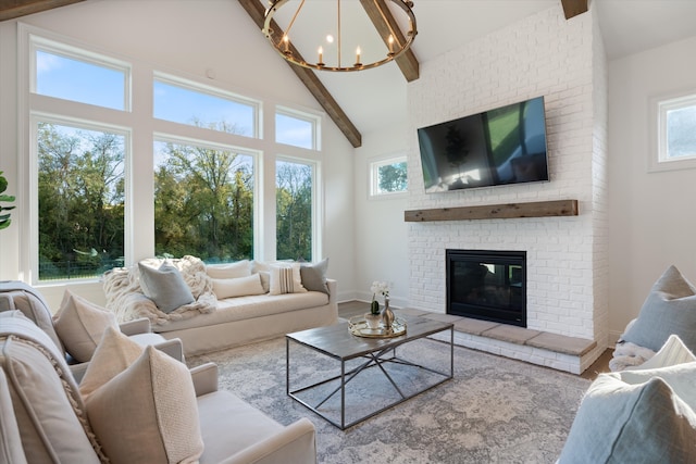 living room featuring high vaulted ceiling, a fireplace, beamed ceiling, a notable chandelier, and wood-type flooring