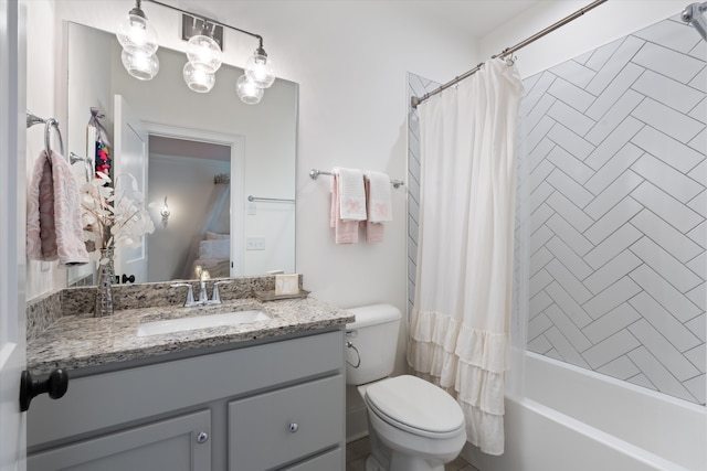 full bathroom featuring vanity, shower / bath combination with curtain, and toilet