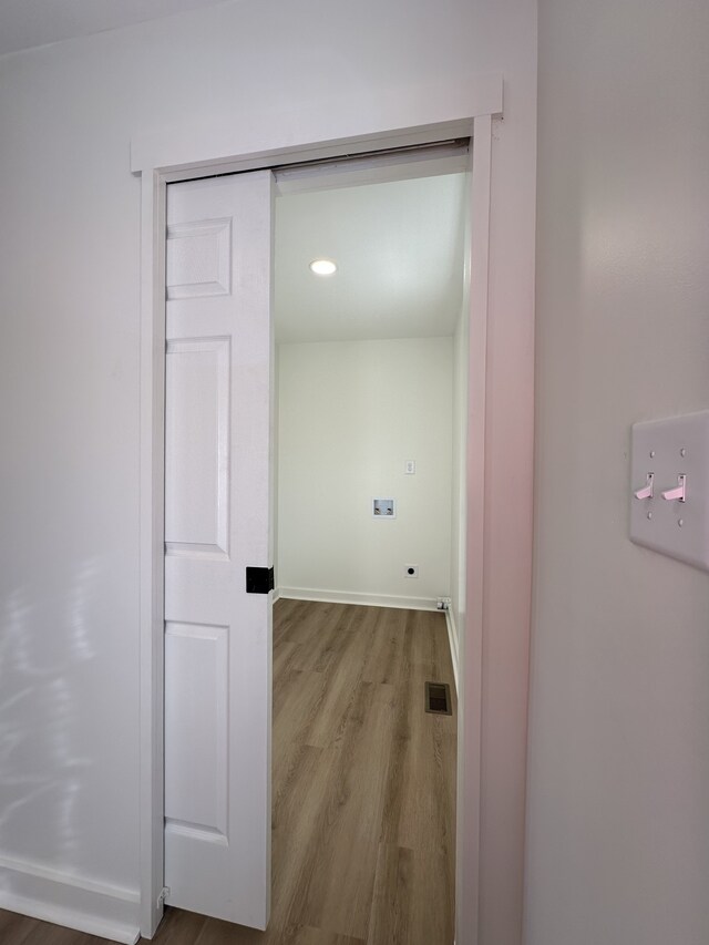 hallway with wood-type flooring