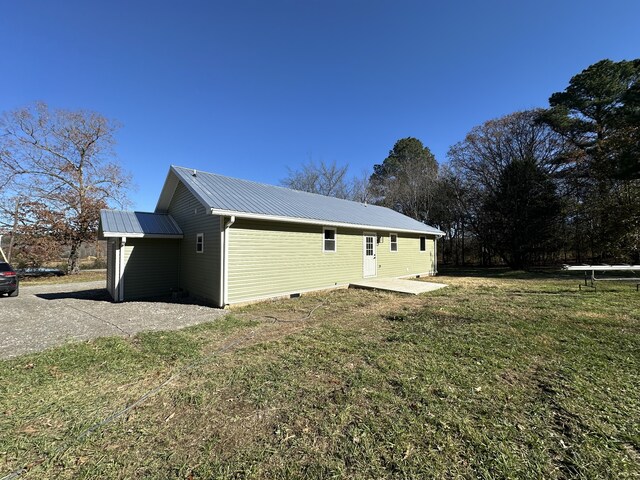 view of side of home featuring a lawn