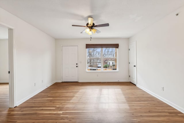 spare room with hardwood / wood-style flooring and ceiling fan