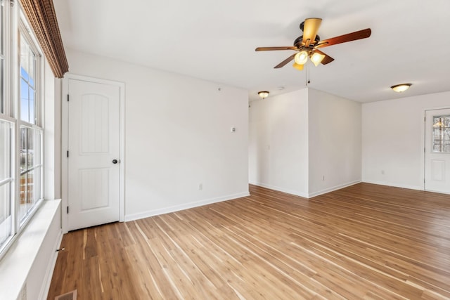 unfurnished room with ceiling fan and light hardwood / wood-style flooring