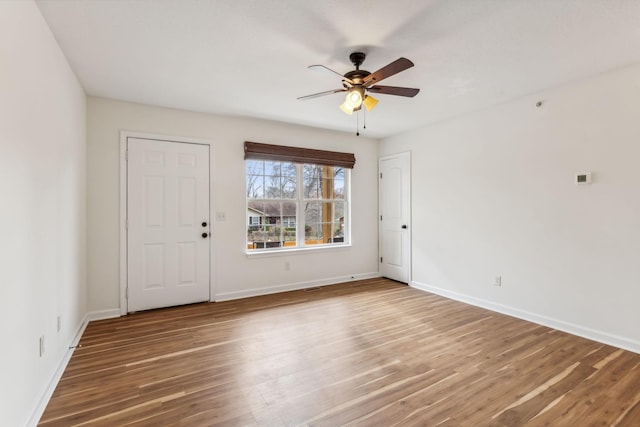 empty room featuring hardwood / wood-style floors and ceiling fan