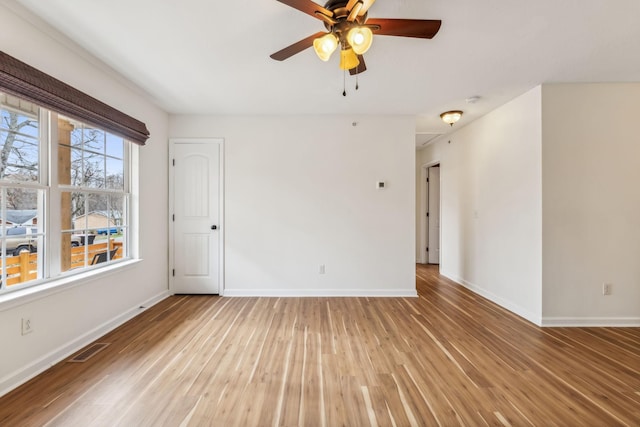 spare room with hardwood / wood-style floors and ceiling fan