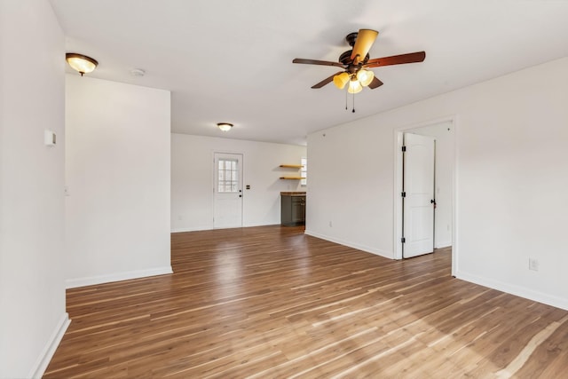 unfurnished living room with ceiling fan and hardwood / wood-style floors