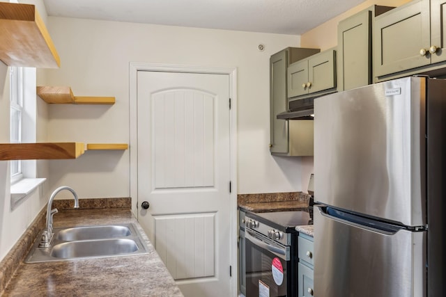 kitchen with sink, stainless steel appliances, and green cabinetry