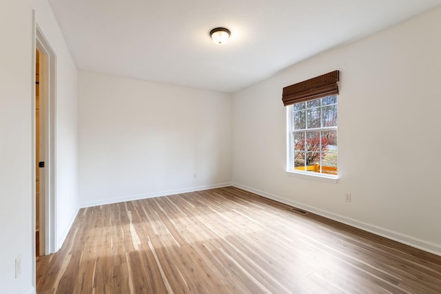 spare room with wood-type flooring