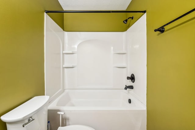 bathroom with toilet, shower / tub combination, and a textured ceiling