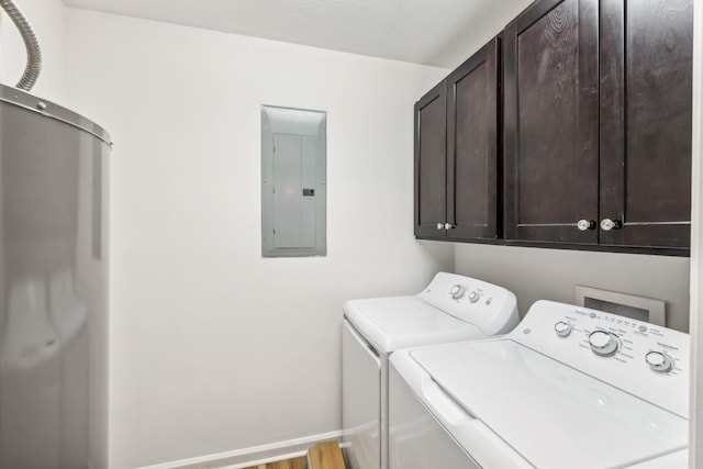 laundry room with cabinets, a textured ceiling, washer and dryer, hardwood / wood-style floors, and electric panel