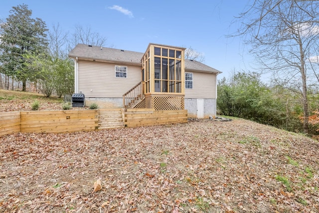 back of property with a sunroom