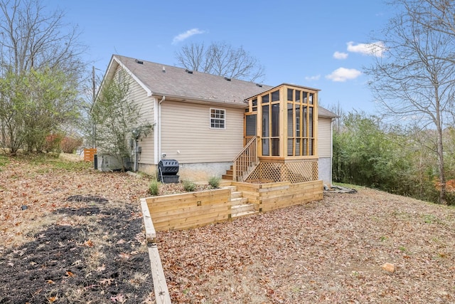 rear view of house with a sunroom