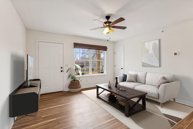 living room featuring ceiling fan and hardwood / wood-style flooring