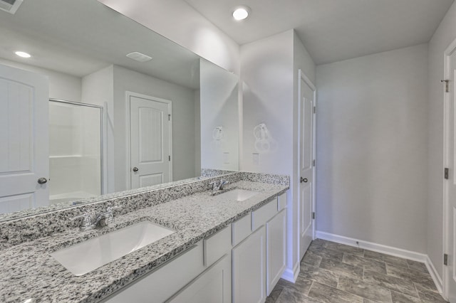 bathroom featuring vanity and an enclosed shower