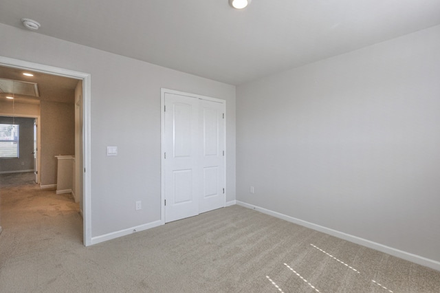 unfurnished bedroom with light colored carpet