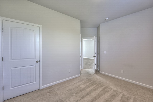 unfurnished bedroom featuring light colored carpet