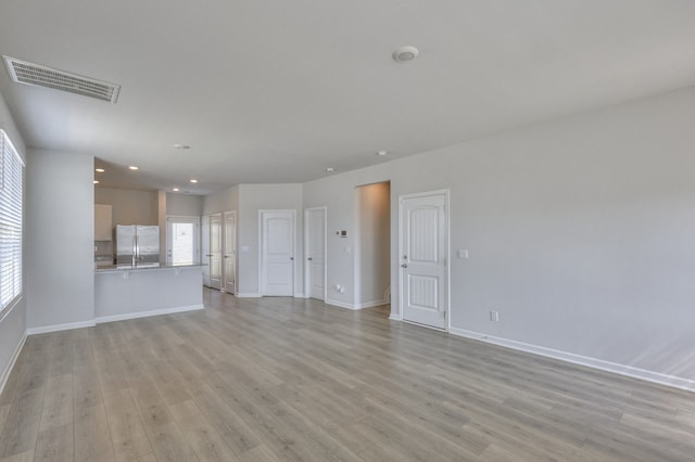 unfurnished living room with light hardwood / wood-style flooring