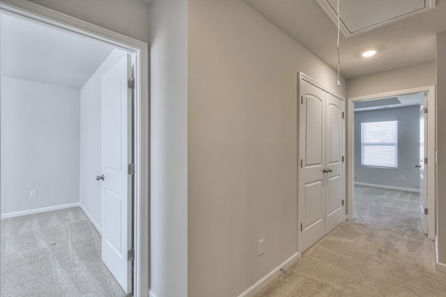 corridor featuring light colored carpet