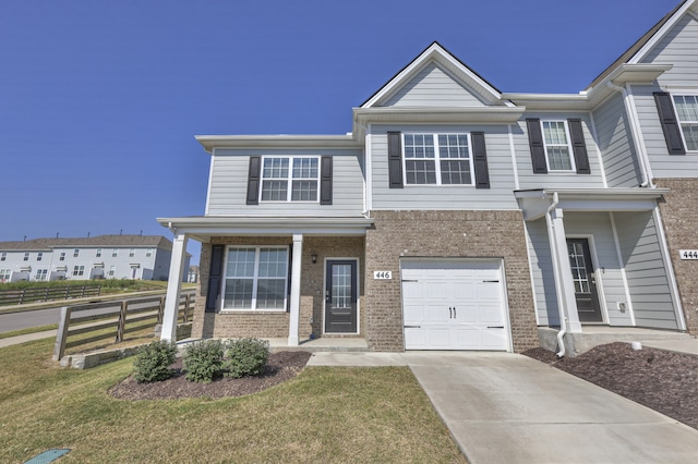 view of property with a front lawn and a garage