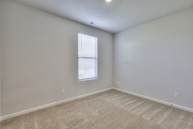 unfurnished room with light colored carpet