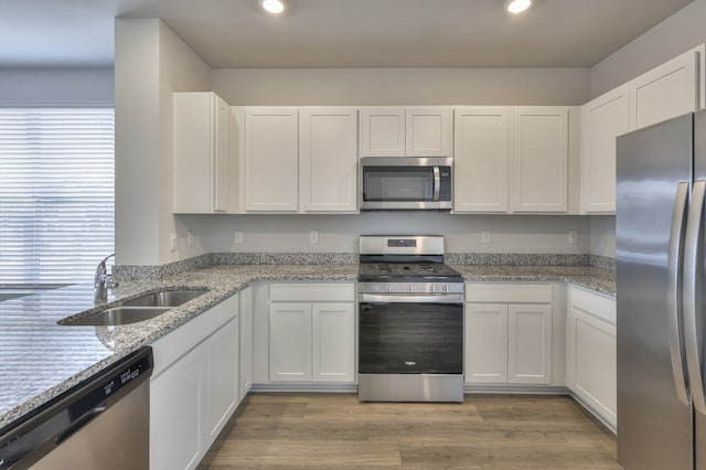 kitchen with white cabinets, stainless steel appliances, and sink