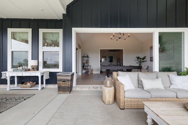 exterior space with a chandelier, hardwood / wood-style floors, and lofted ceiling