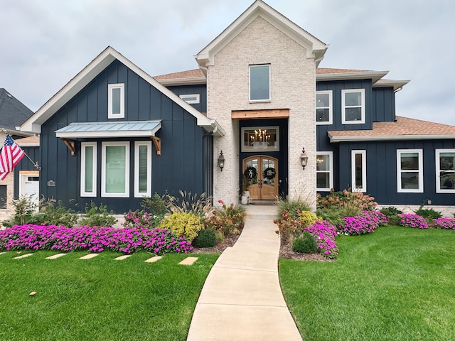 view of front of home with french doors and a front yard