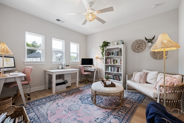 living room with hardwood / wood-style floors and ceiling fan