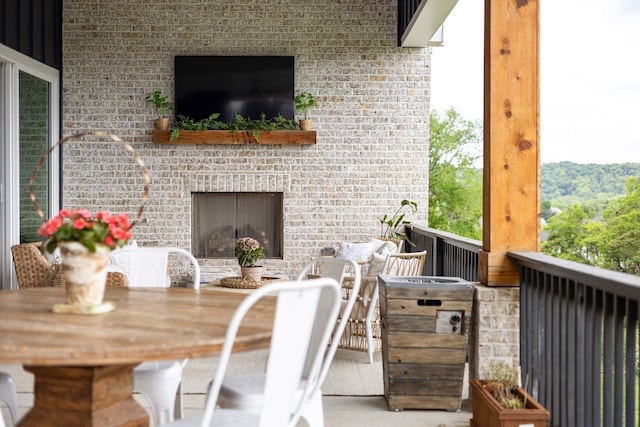 view of patio with an outdoor brick fireplace