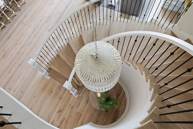 stairs featuring hardwood / wood-style flooring and wood walls