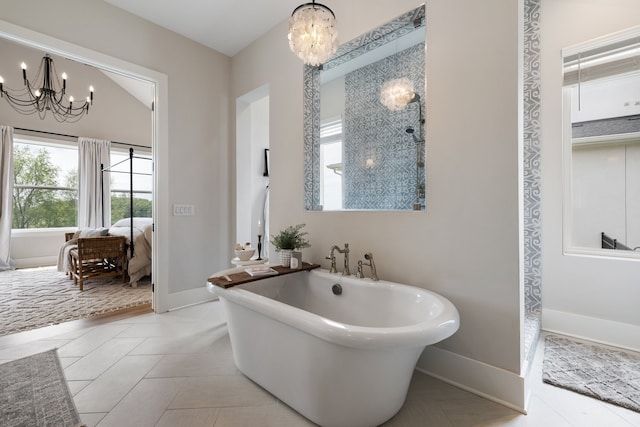 bathroom featuring tile patterned floors, a bathing tub, and a chandelier